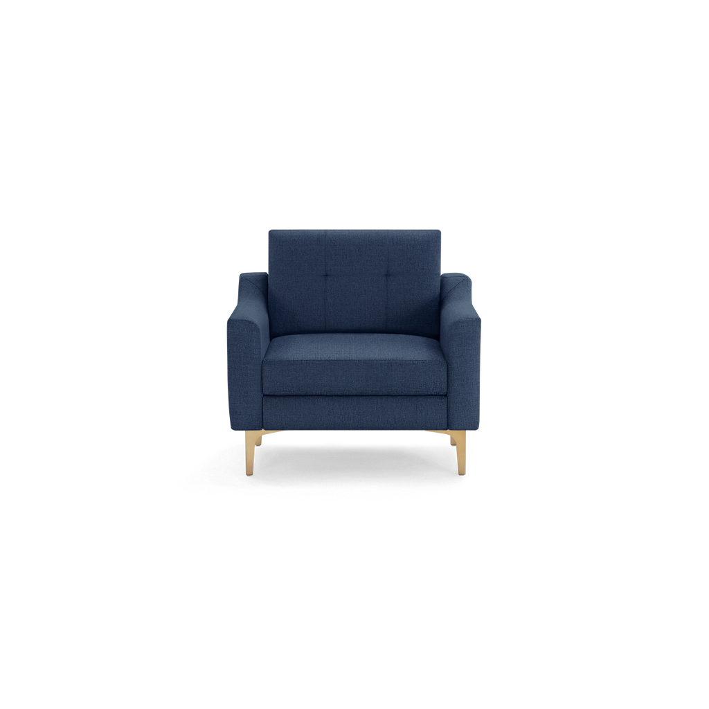 Modern navy blue upholstered armchair with button-tufted backrest and light wooden legs, shown against a plain background.