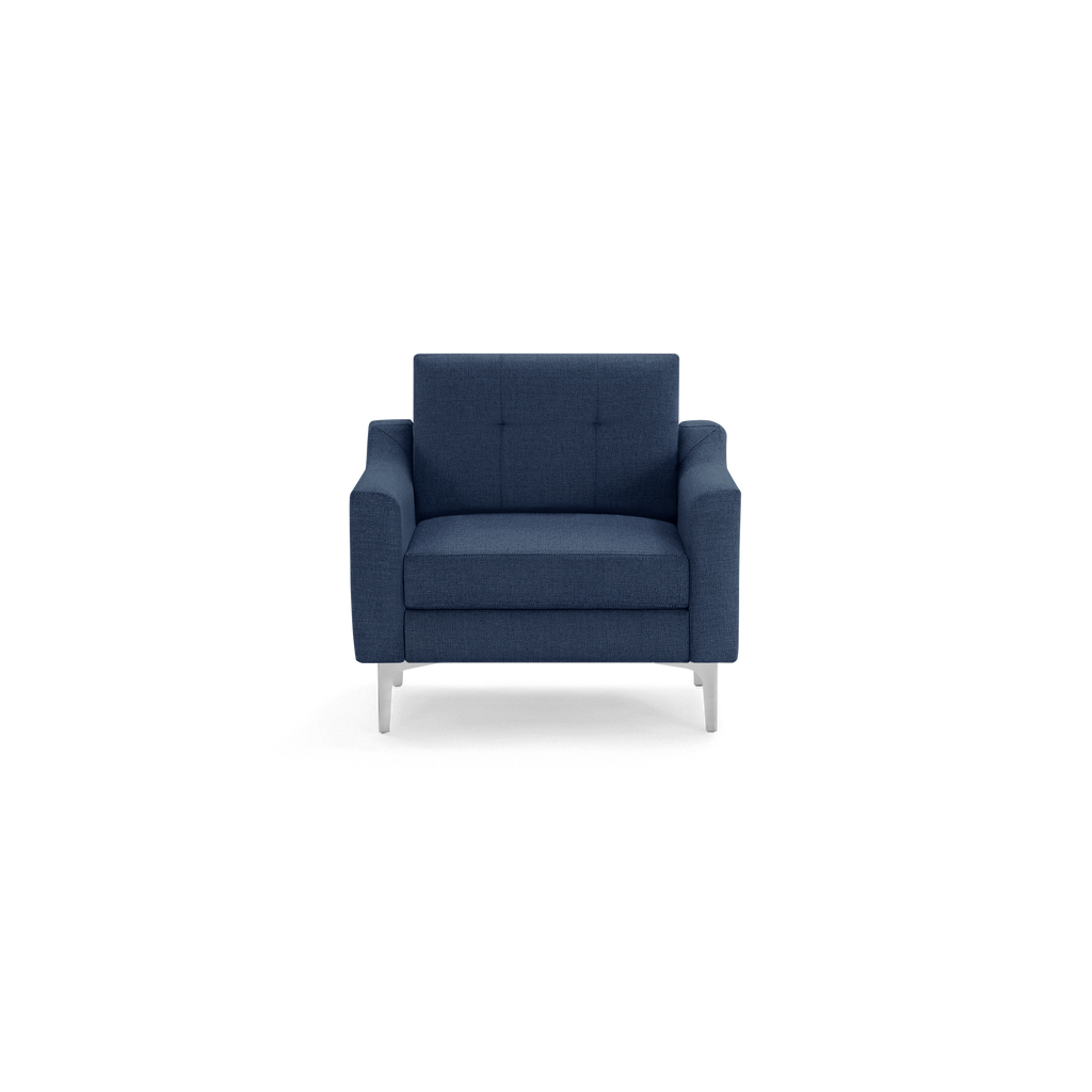 Modern navy blue upholstered armchair with tufted back, wide armrests, and silver metal legs, shown from the front.