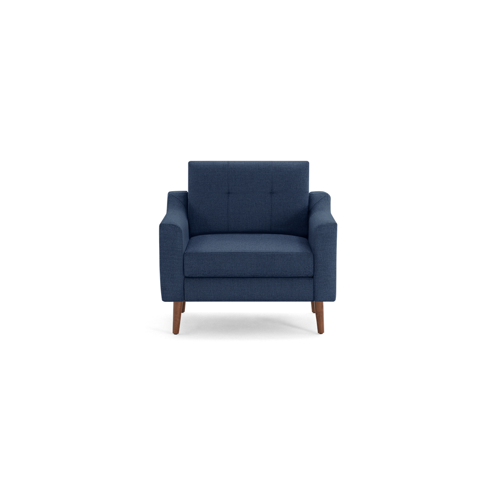 Mid-century modern navy blue fabric armchair with tufted backrest and wooden legs, shown from the front on a white background.
