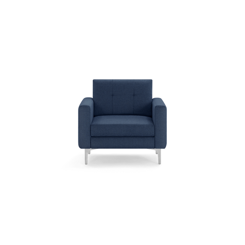Modern navy blue upholstered armchair with tufted backrest, squared armrests, and sleek silver metal legs.