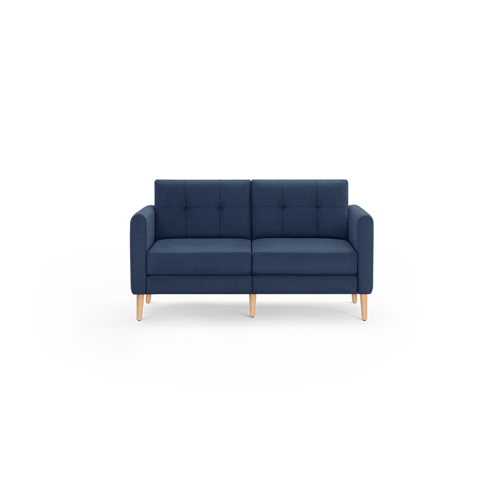 Modern navy blue two-seater sofa with button-tufted back cushions and light wooden tapered legs, shown on a white background.