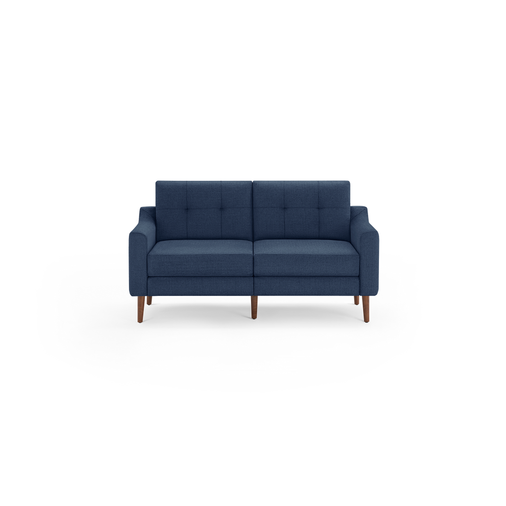 Modern navy blue fabric loveseat with tufted backrest, plush cushions, and wooden tapered legs.