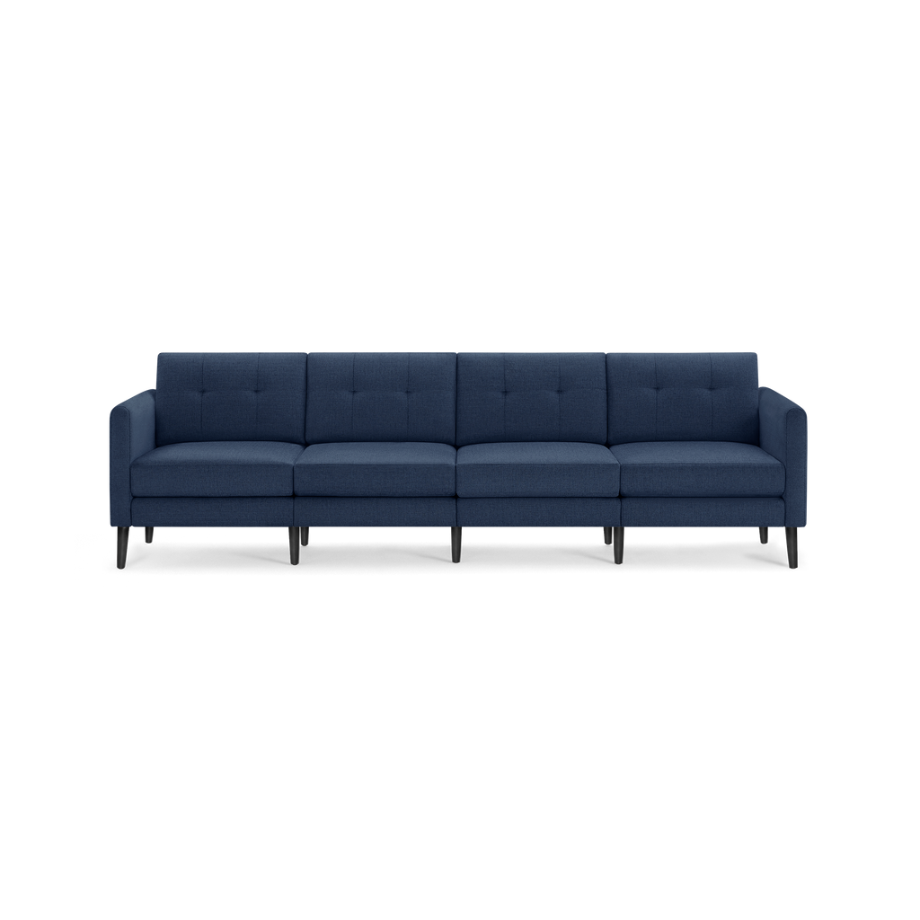 Four-seat modern sectional sofa in dark blue fabric with tufted back cushions and black tapered wooden legs.
