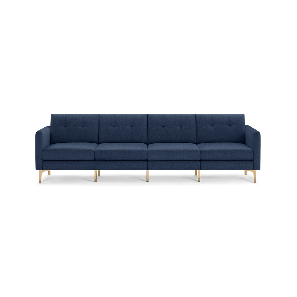 Modern navy blue fabric sofa with four cushioned seats, button-tufted backrests, and sleek gold metal legs.