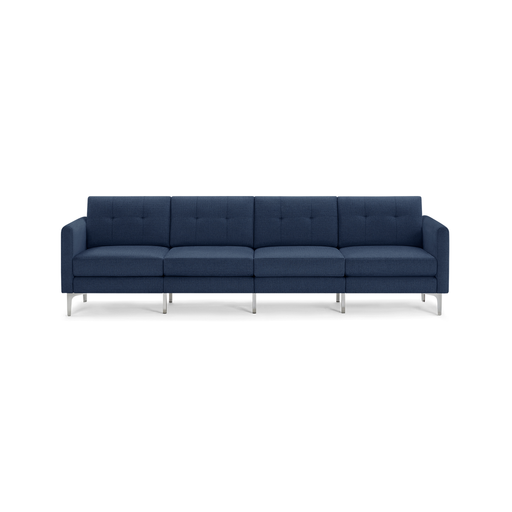 Modern four-seater sofa in dark blue fabric with metal legs and tufted back cushions, clean-lined and minimalistic design.