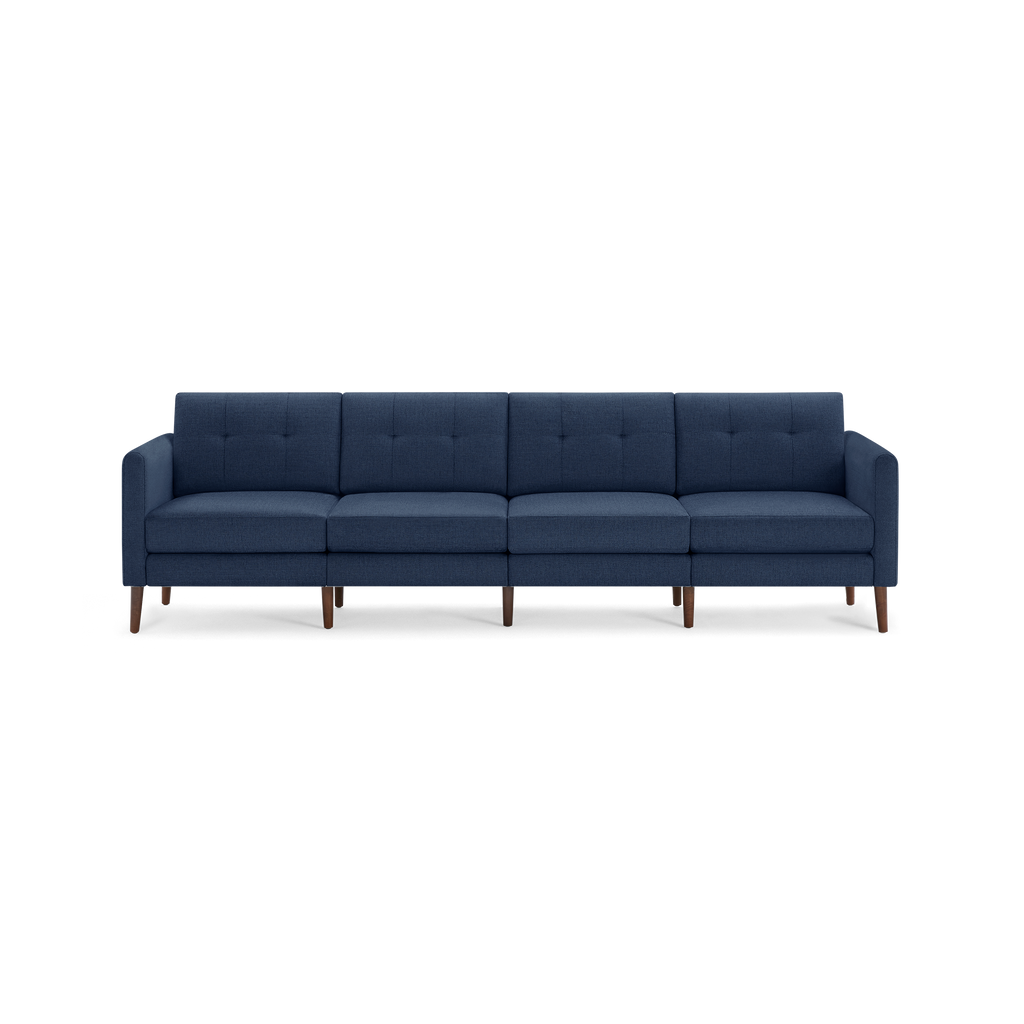 Four-seater modern navy blue fabric sofa with tufted back cushions and wooden legs, featuring clean lines and armrests.
