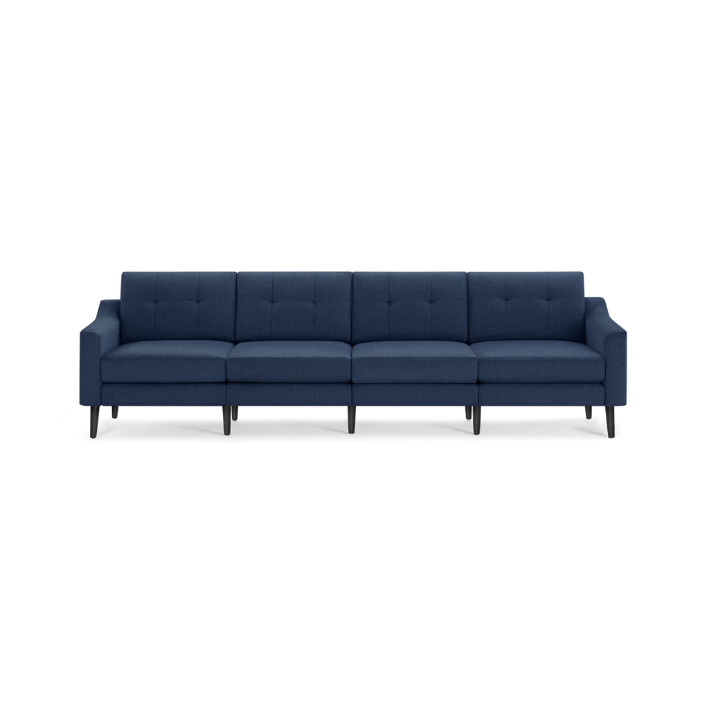 Modern navy blue fabric sofa with tufted backrest, straight armrests, and black tapered wooden legs, seating four people comfortably.
