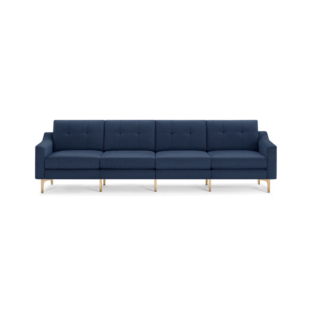 Modern four-seater navy blue fabric sofa with tufted back cushions and gold metal legs, featuring clean lines and a minimalist design.