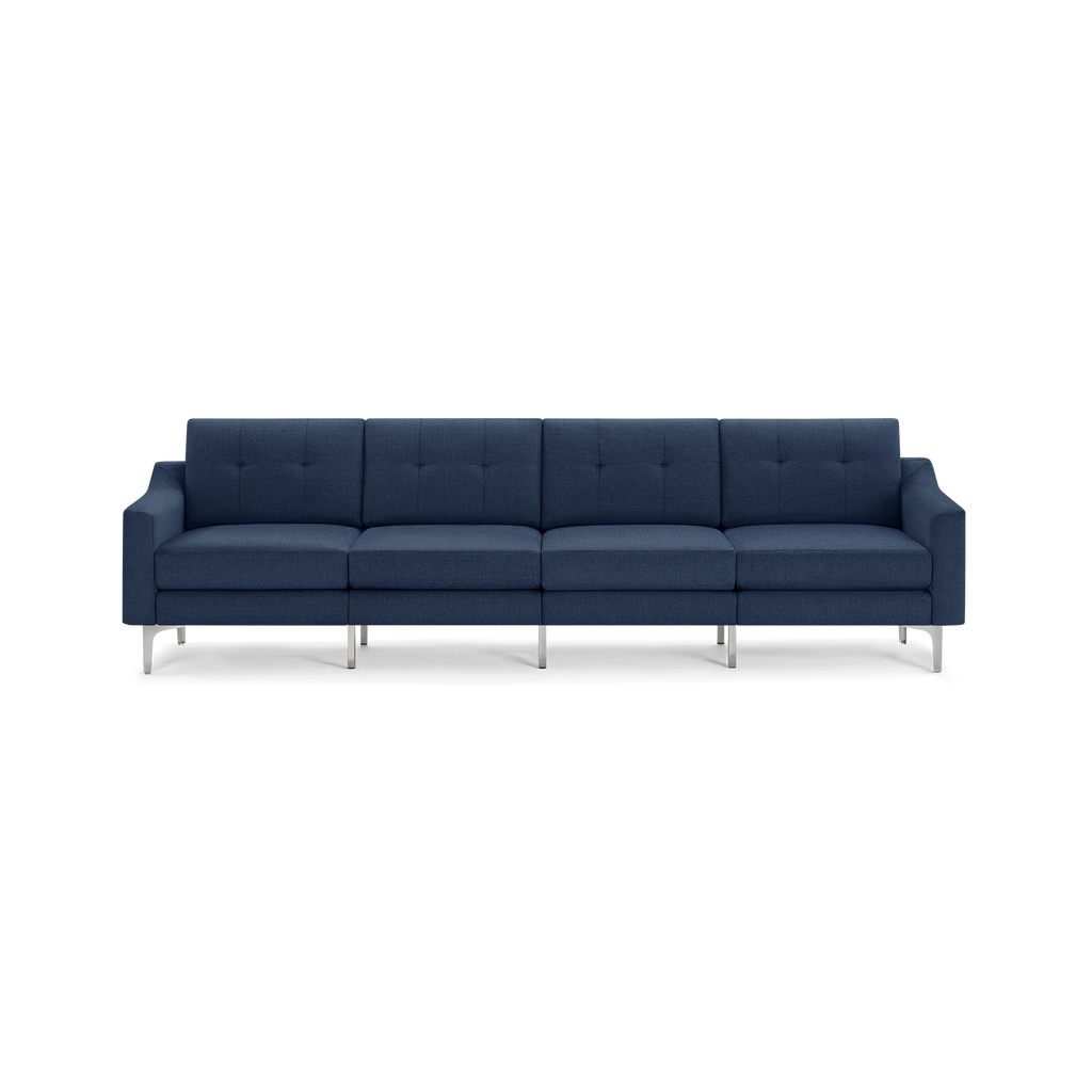 Modern navy blue fabric sofa with four seats, tufted back cushions, and sleek metal legs.