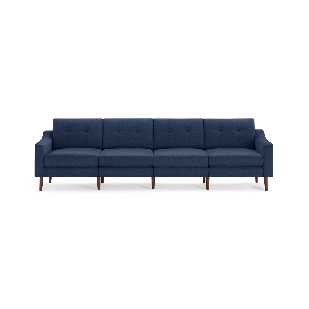 Modern navy blue fabric sofa with tufted back cushions and wooden tapered legs, seating four people comfortably.