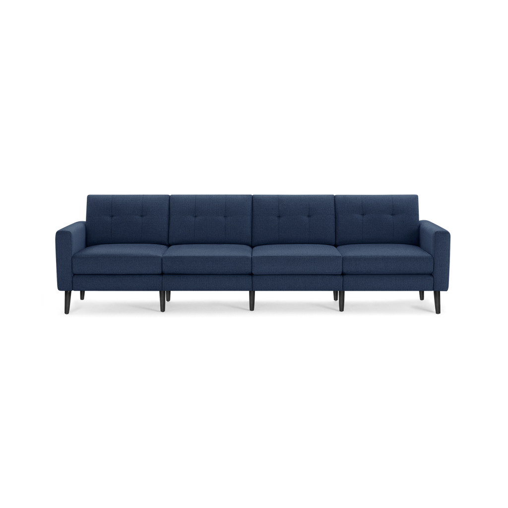 Modern navy blue fabric sectional sofa with tufted back cushions, straight arms, and black tapered wooden legs.
