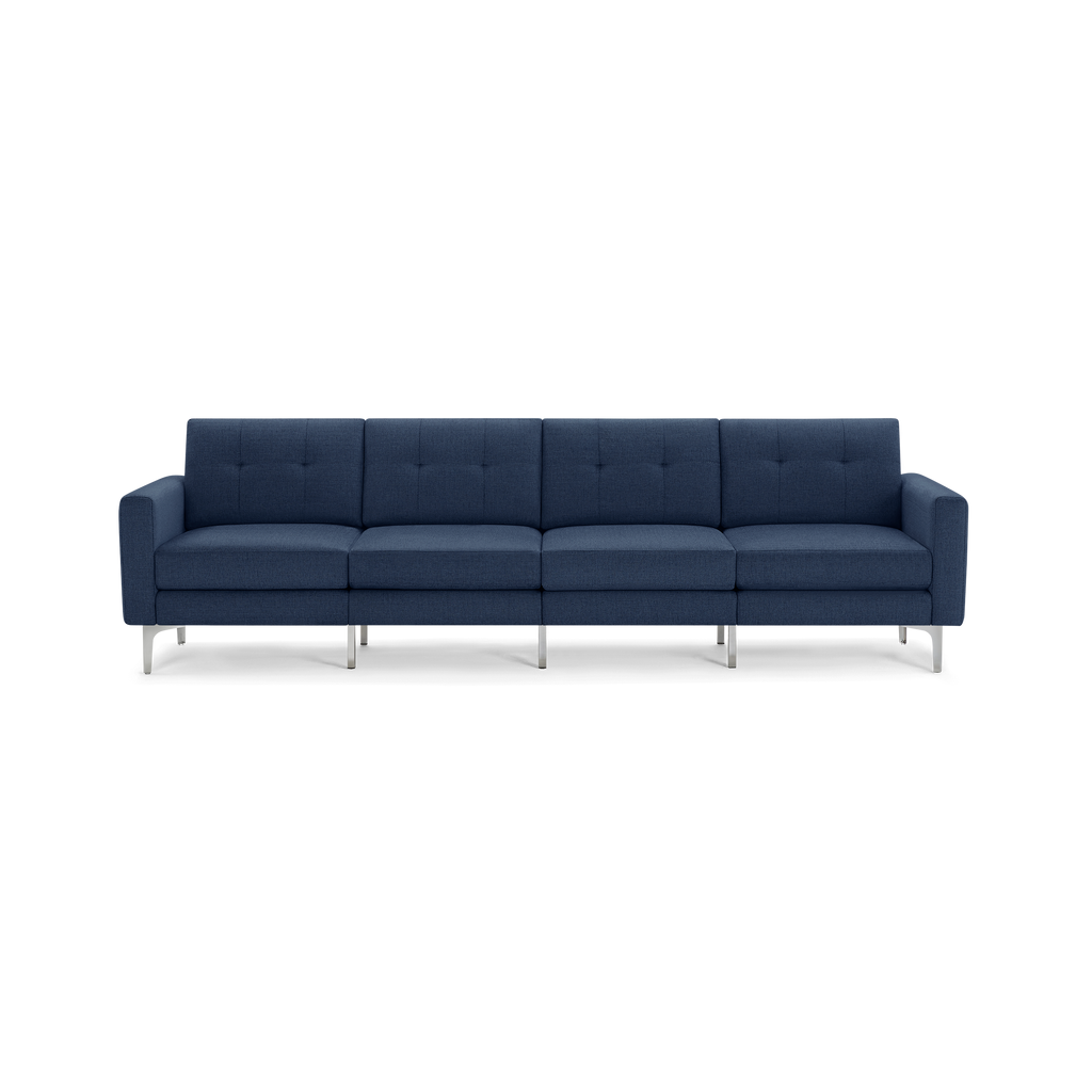 Modern navy blue four-seater sofa with metal legs, button-tufted back cushions, and squared armrests on a black background.
