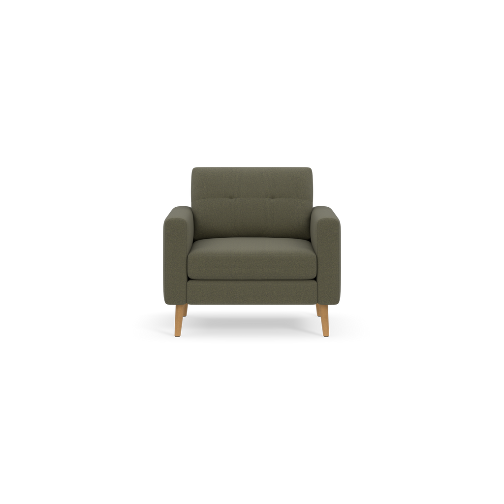 A modern olive-green armchair with padded seat, tufted backrest, and wooden legs, shown on black background.