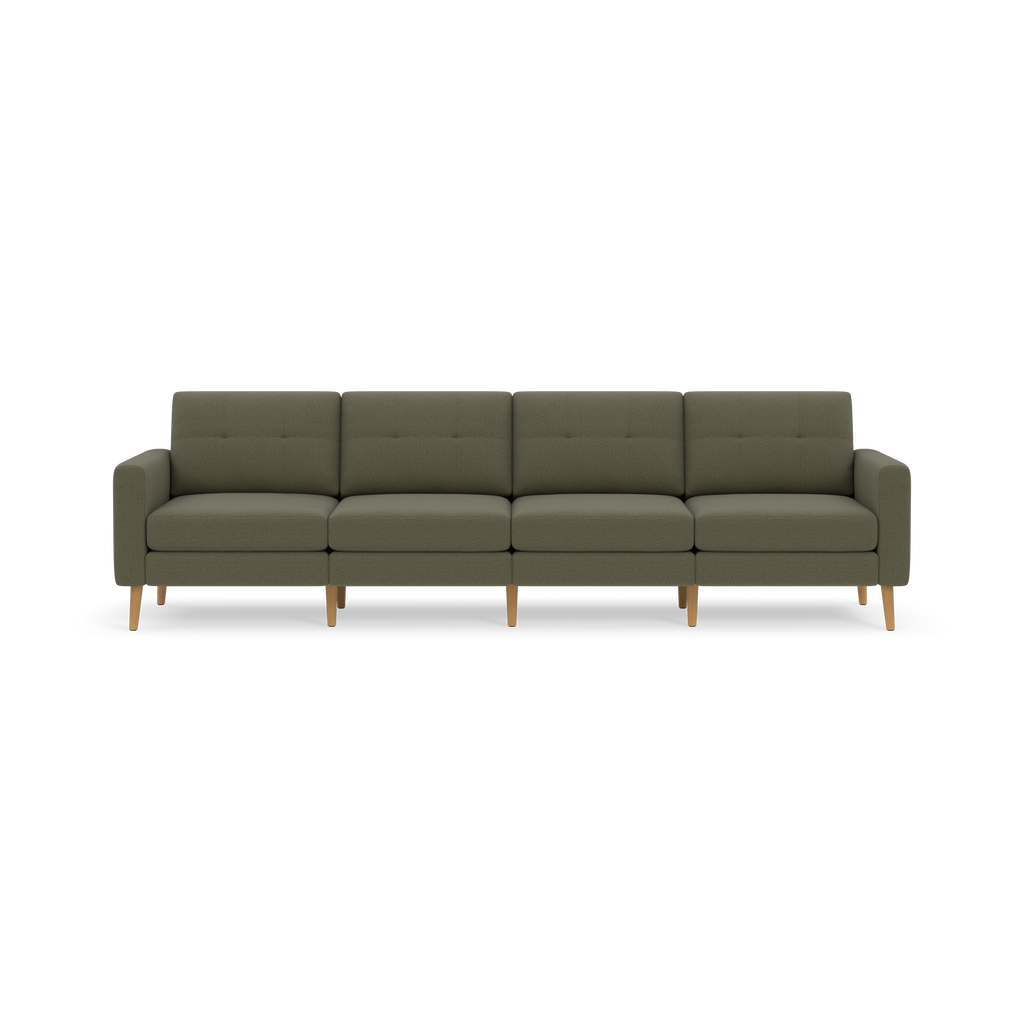 Modern Moss green four-seat sofa with tufted back cushions and light wooden legs, set against a black background.