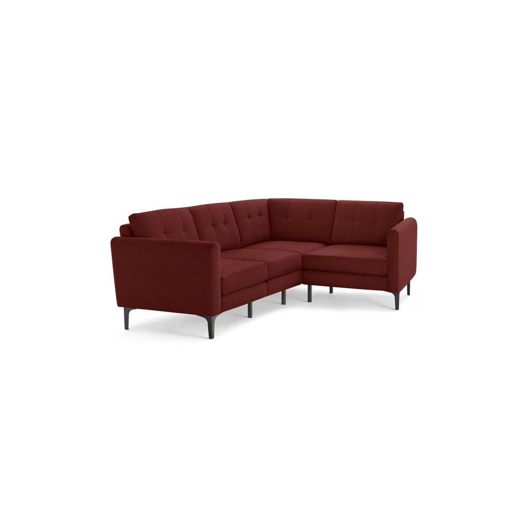Modern L-shaped sectional sofa in deep red fabric with tufted back cushions and slender black metal legs.