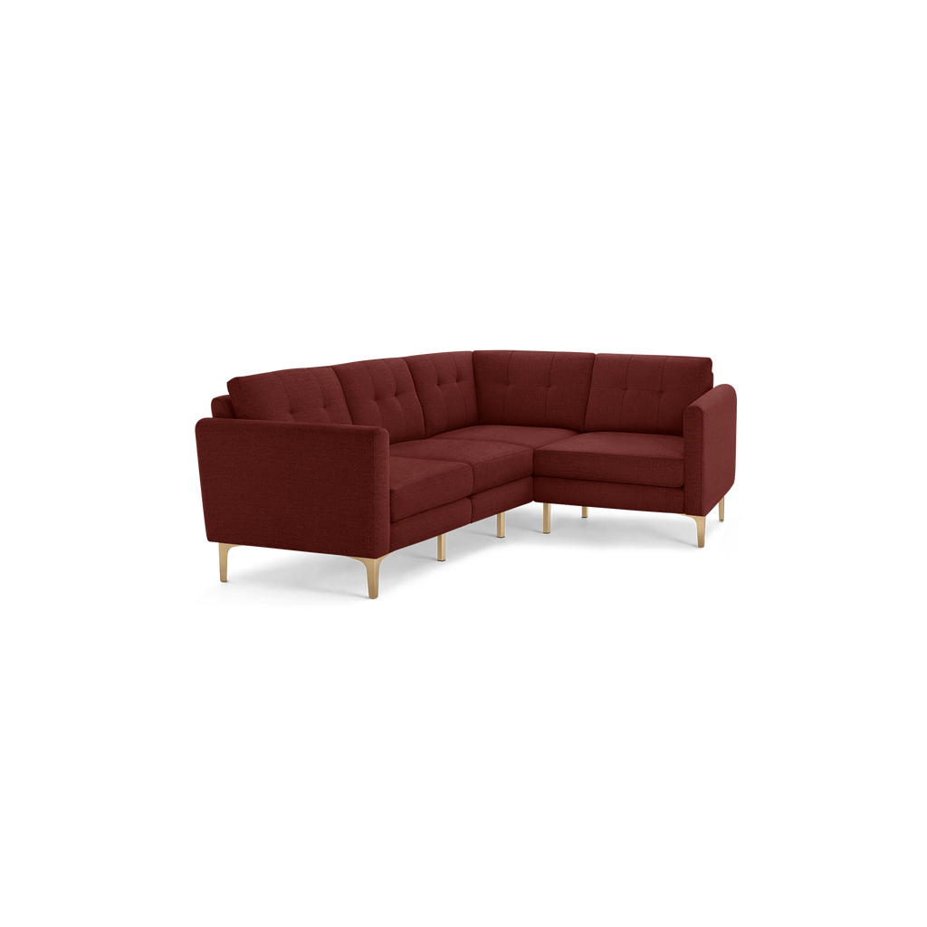 L-shaped burgundy fabric sectional sofa with tufted backrest cushions and light wooden legs, modern and cozy design.