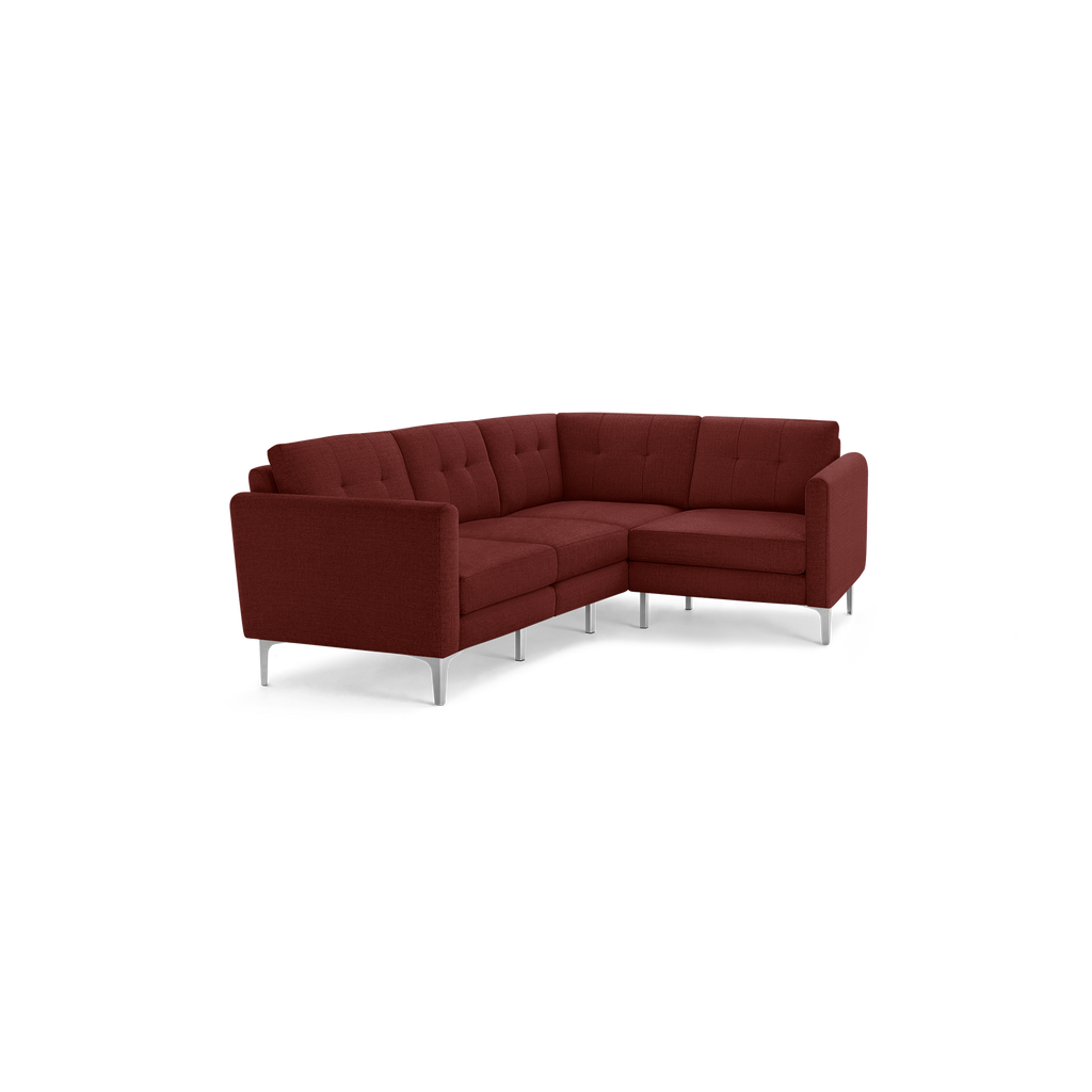 Modern L-shaped sectional sofa in deep red fabric with tufted back cushions and sleek metal legs.