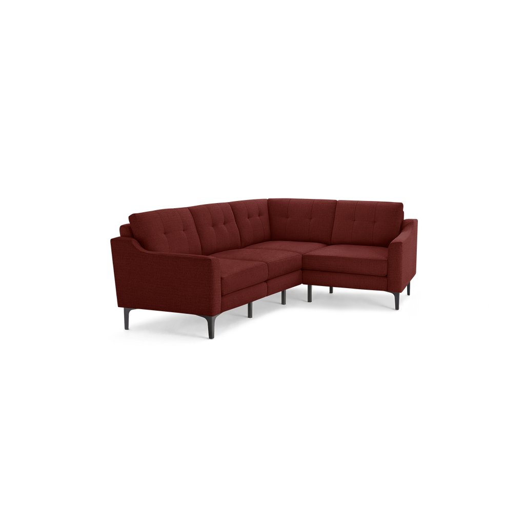 Modern L-shaped sectional sofa in deep red fabric with tufted back cushions and slim black metal legs.