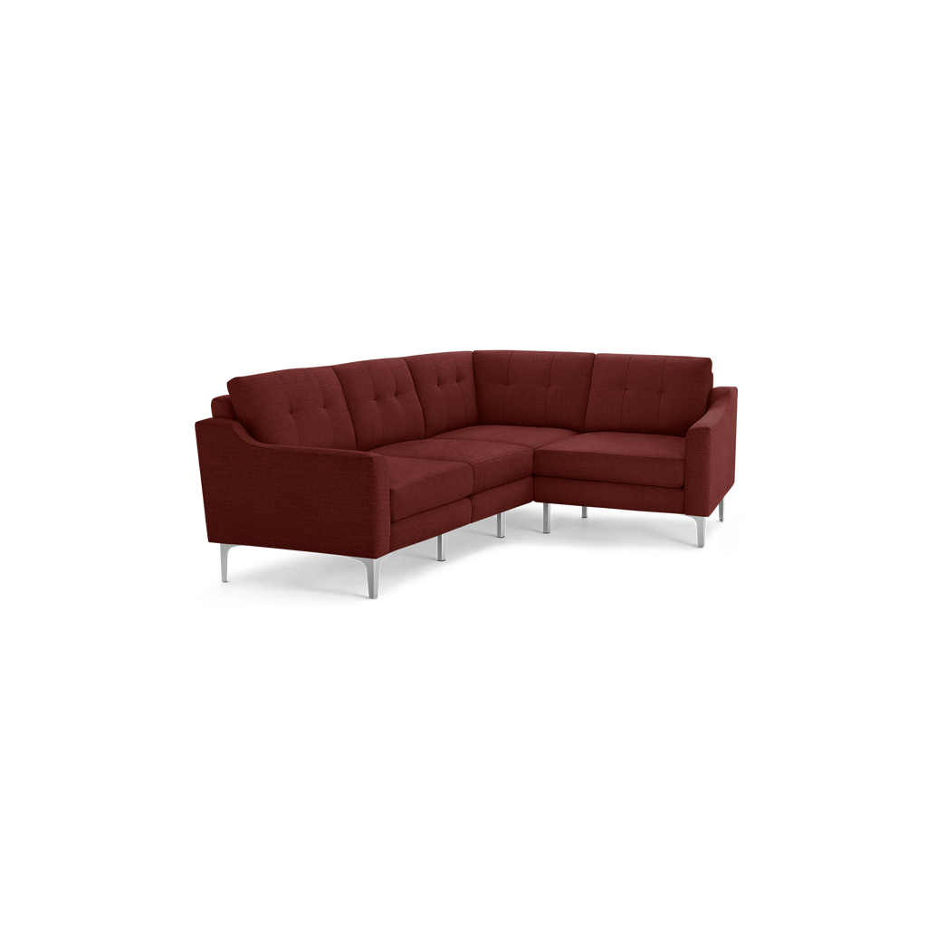 Modern L-shaped sectional sofa upholstered in deep red fabric with tufted back cushions and sleek metal legs.