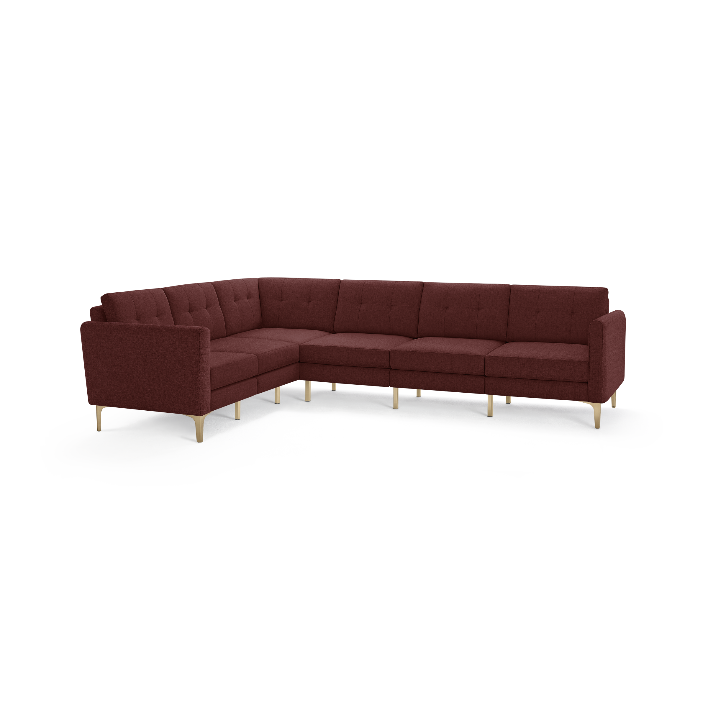 Large L-shaped sectional sofa upholstered in deep burgundy fabric with tufted back cushions and light wooden legs.