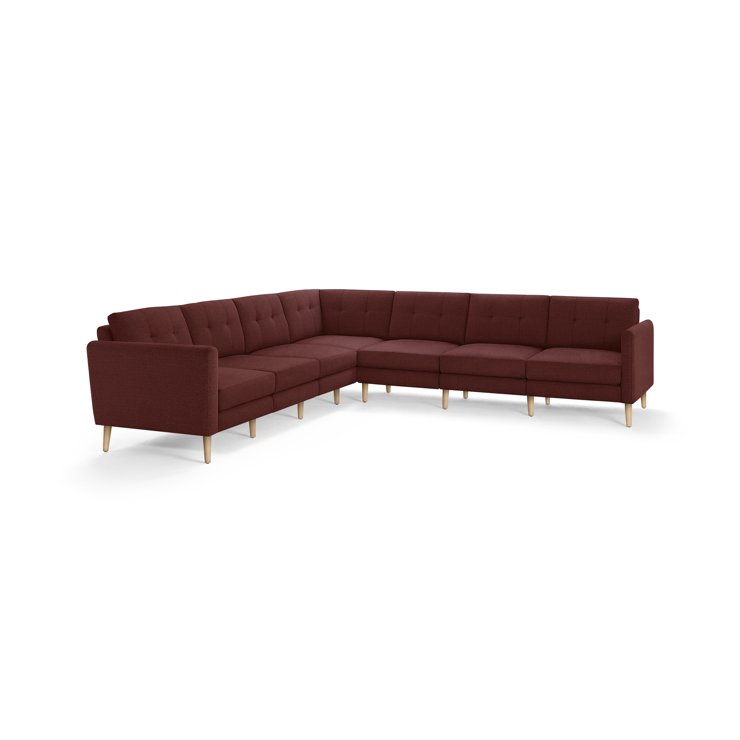 L-shaped sectional sofa in burgundy fabric with tufted back cushions and light wooden legs.