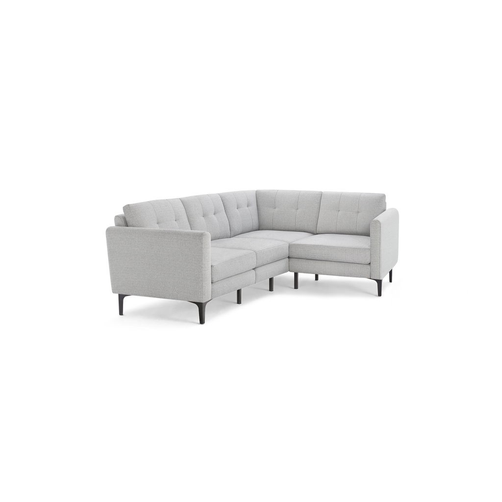 Light gray modern L-shaped sectional sofa with tufted back cushions and slim black metal legs on a white background.