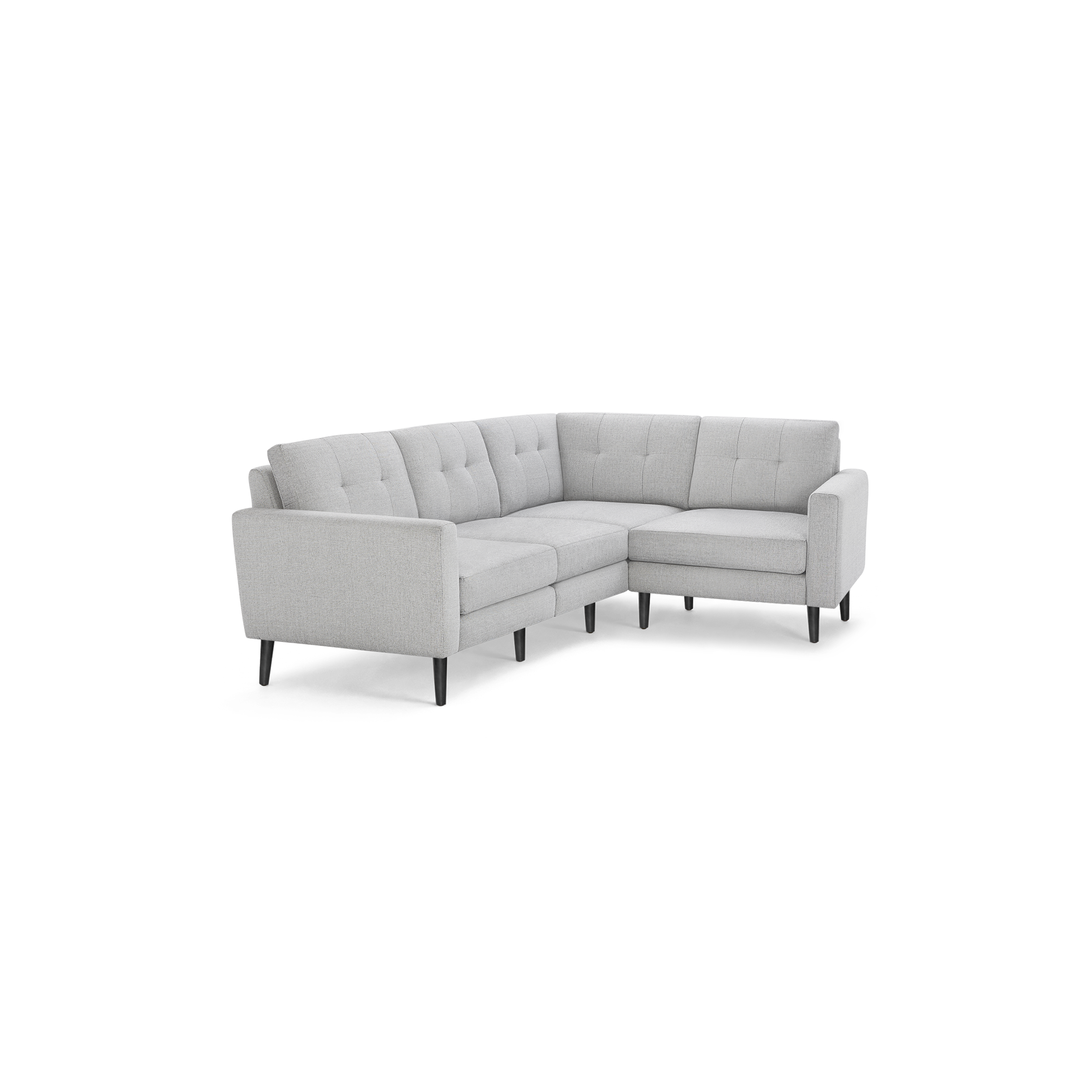 Light gray fabric L-shaped sectional sofa with tufted back cushions and slim dark wooden legs on black background.
