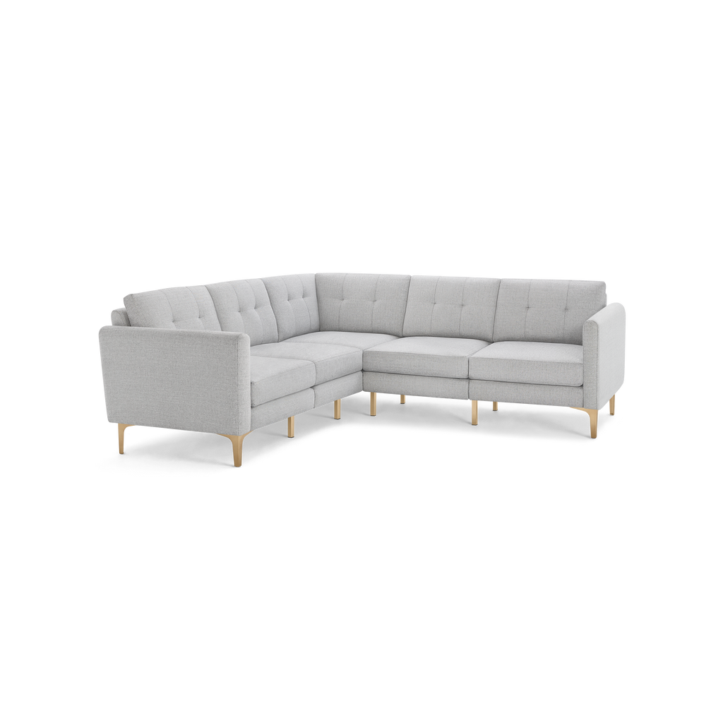 Light gray fabric upholstered L-shaped sectional sofa with tufted back cushions and wooden legs.