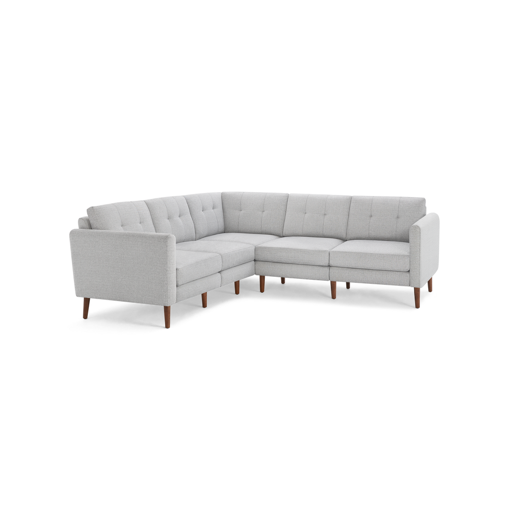 Light gray fabric sectional sofa with tufted back cushions and wooden legs, designed in an L-shape for corner seating.