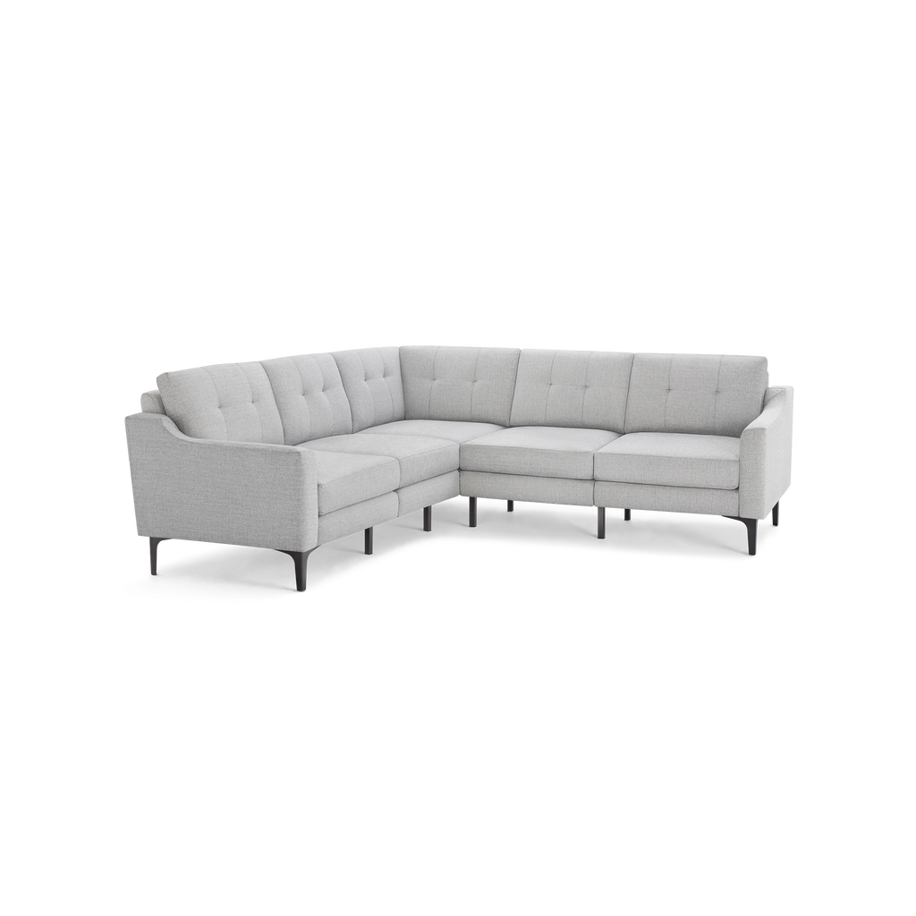Light gray fabric sectional sofa with tufted back cushions, modern slim armrests, and black tapered legs.