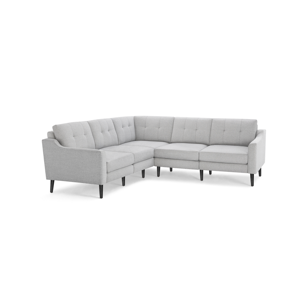 Light gray fabric sectional sofa with tufted back cushions and tapered wooden legs in a modern L-shape design.