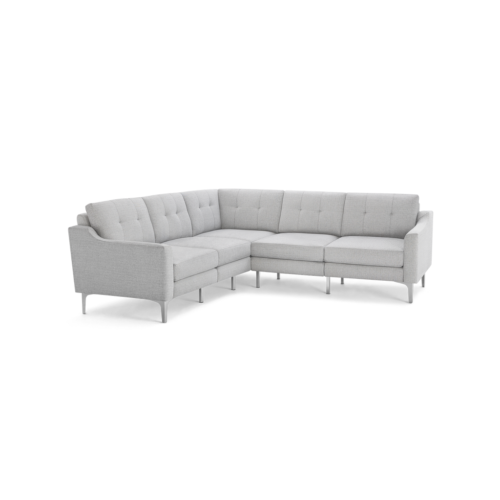 Light gray modern L-shaped sectional sofa with tufted back cushions, slim armrests, and metal legs on a black background.