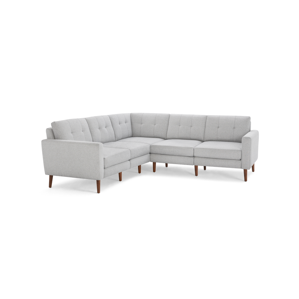 Light gray L-shaped sectional sofa with tufted cushions and wooden legs, modern mid-century design.