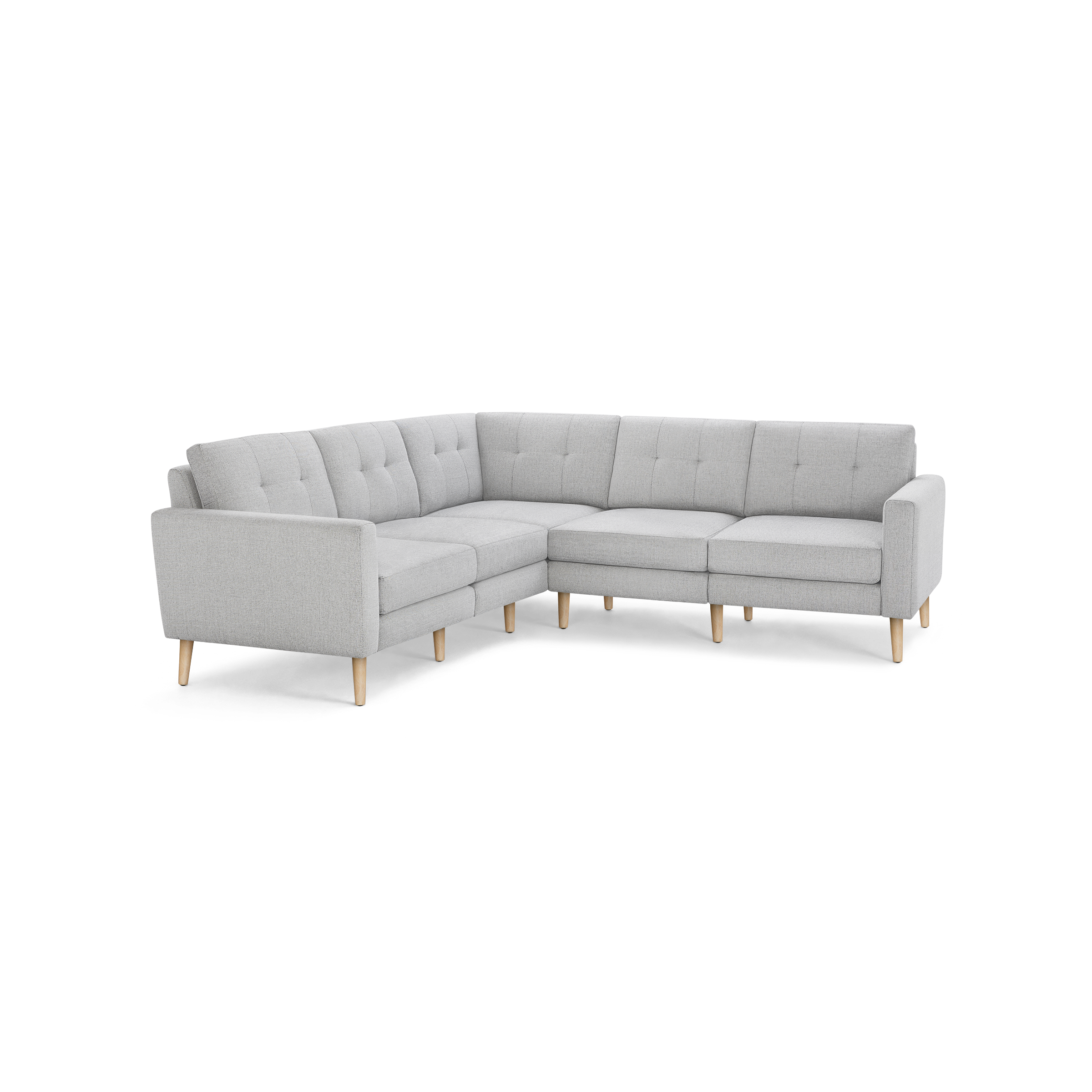 Light gray L-shaped sectional sofa with tufted back cushions and wooden tapered legs on black background.