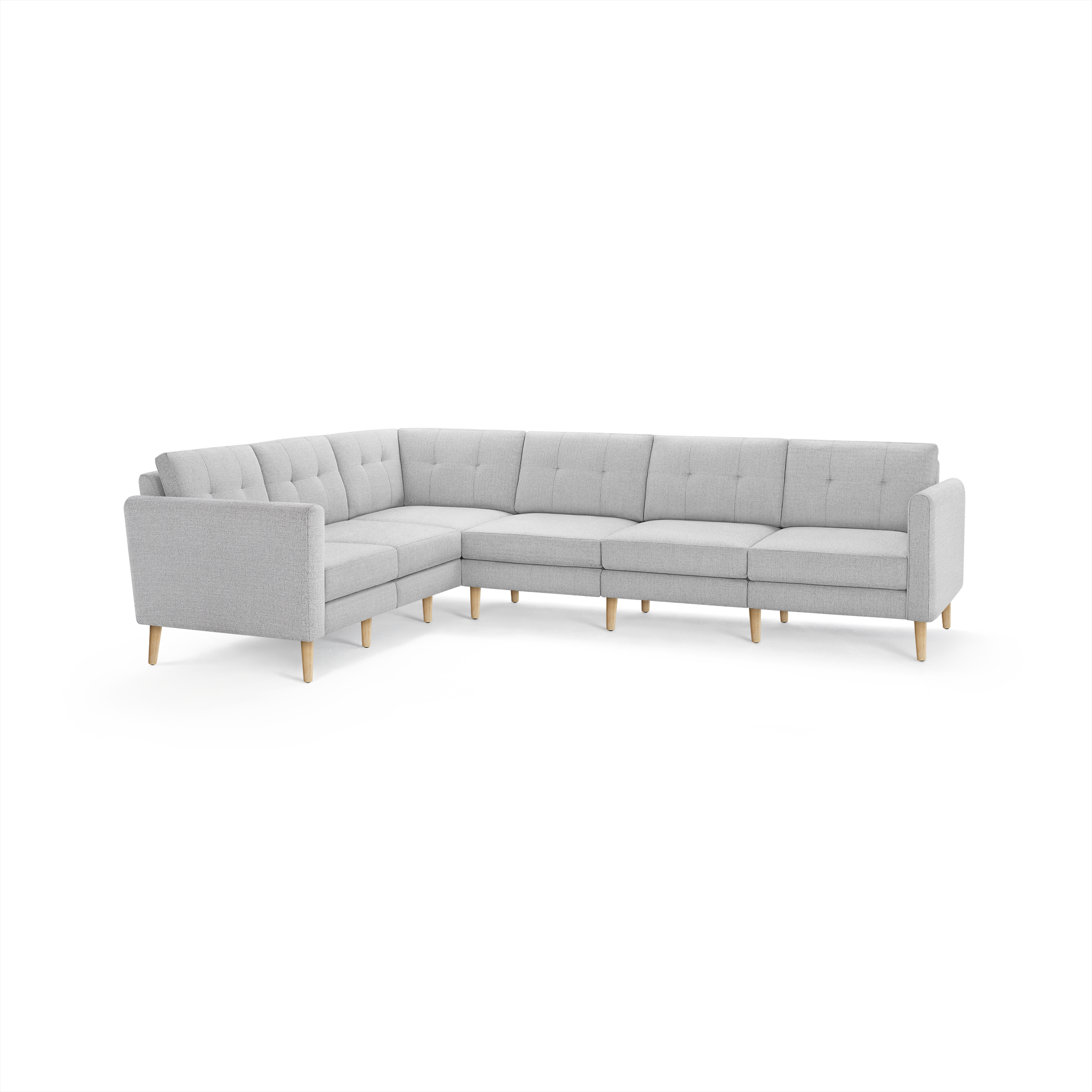 Light gray fabric sectional sofa with tufted back cushions and wooden legs, featuring an L-shaped design.