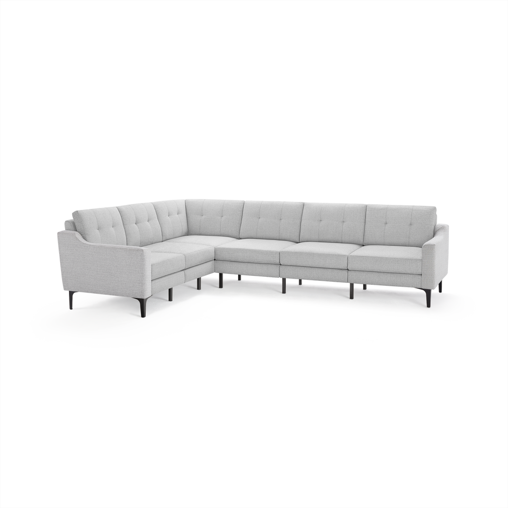 Light gray L-shaped sectional sofa with tufted back cushions and slim black legs, modern minimalist design.