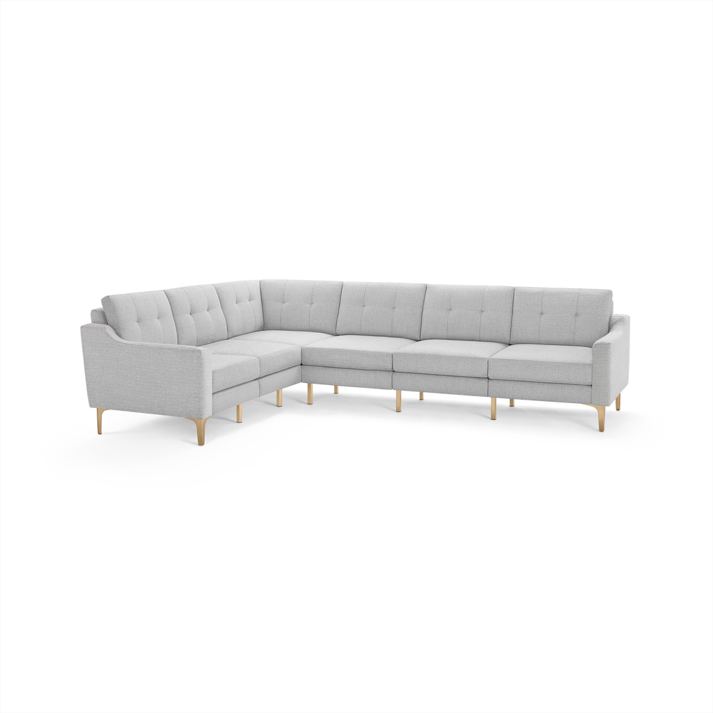 Light gray L-shaped sectional sofa with tufted back cushions and wooden legs, featuring a modern, minimalist design.