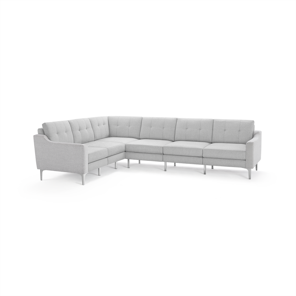 Light gray fabric sectional sofa with tufted back cushions, modern metal legs, and a right-angle corner design.