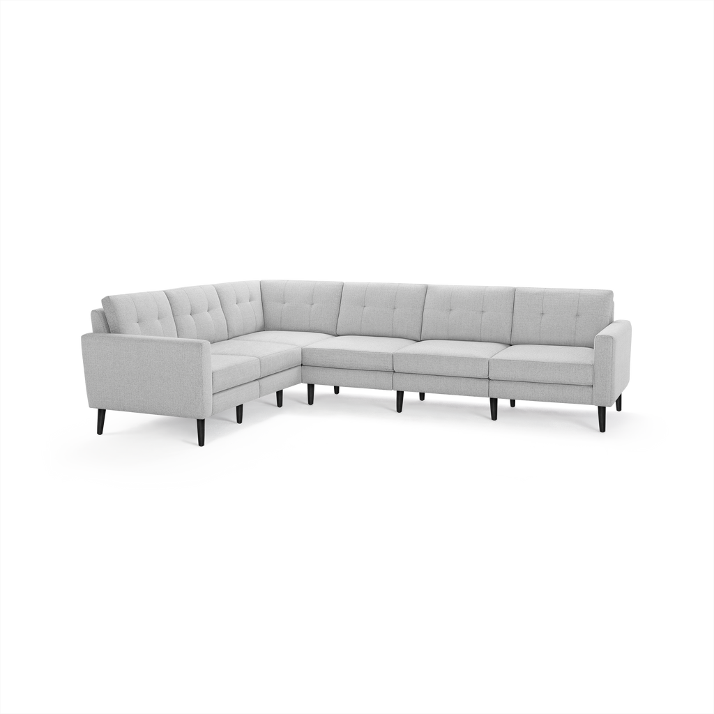 Light gray L-shaped sectional sofa with tufted back cushions and slim black legs, modern minimalist design.