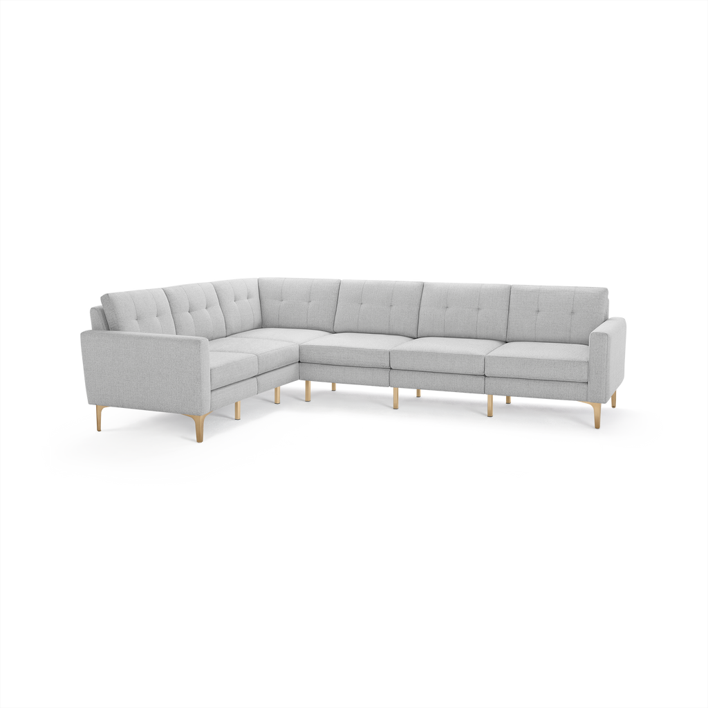 Light gray modern L-shaped sectional sofa with tufted cushions and light wooden legs, designed for spacious seating.