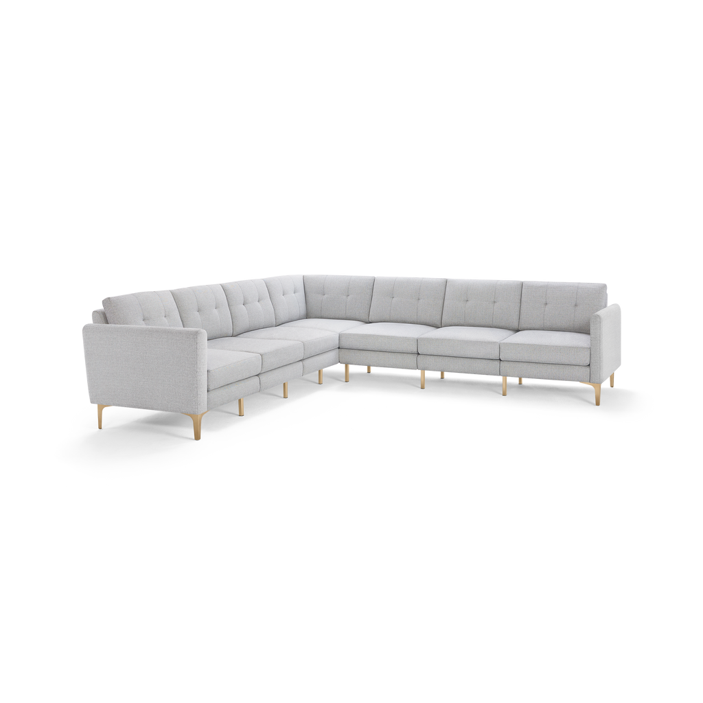 Light gray L-shaped sectional sofa with tufted cushions and wooden legs, modern and minimalist design.