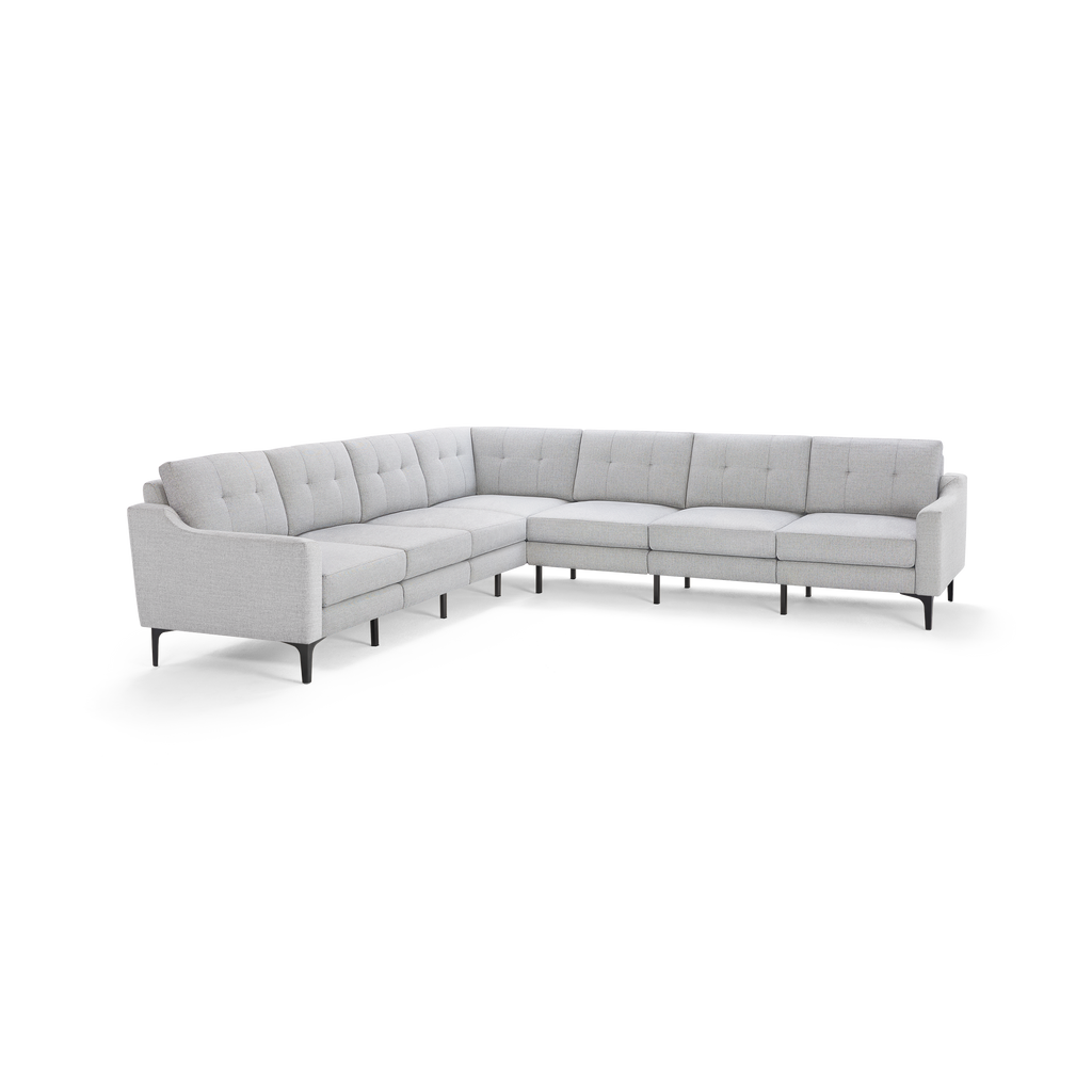 Light gray L-shaped sectional sofa with tufted cushions, slim black legs, and modern mid-century design.