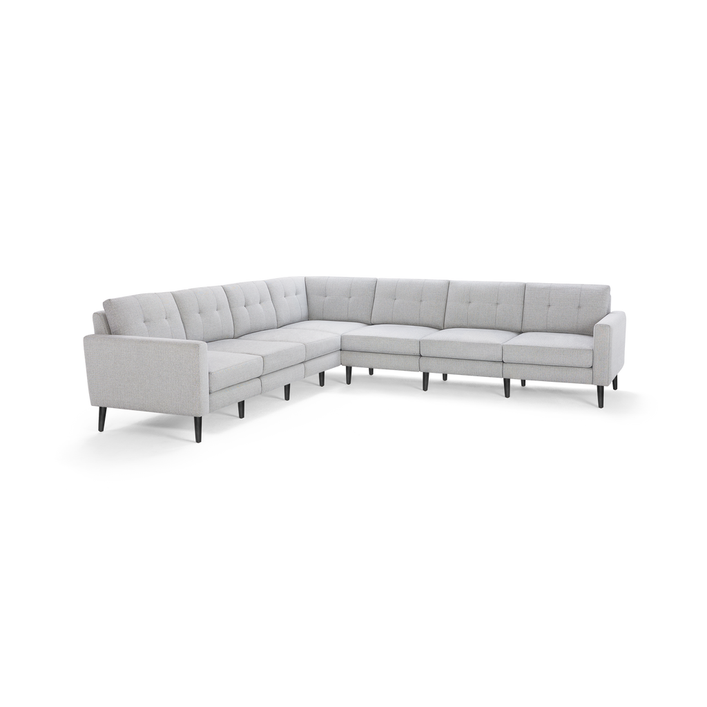 Light gray L-shaped sectional sofa with tufted back cushions and slim black legs, designed for modern living spaces.