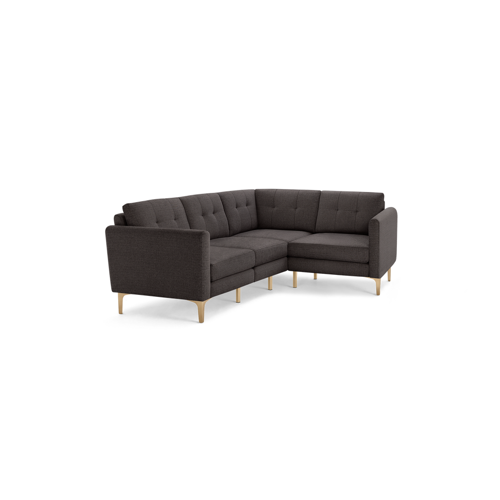 Modern dark gray L-shaped sectional sofa with tufted cushions and light wooden legs, designed for living room comfort and style.