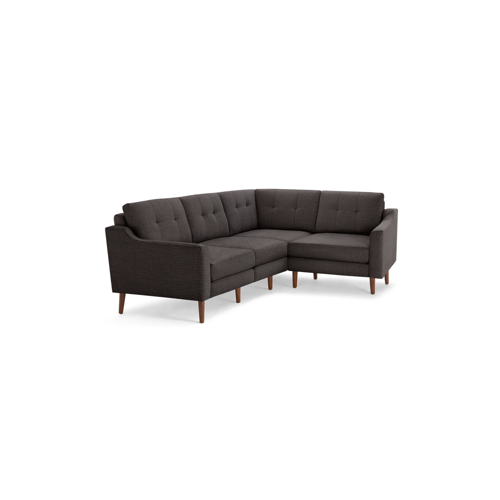 Dark gray L-shaped sectional sofa with tufted cushions and wooden tapered legs, modern mid-century design, offering comfortable seating for living rooms.
