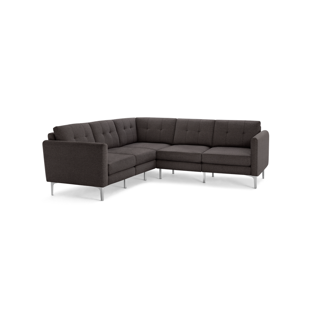 Modern L-shaped sectional sofa in dark gray fabric with tufted back cushions and silver metal legs.