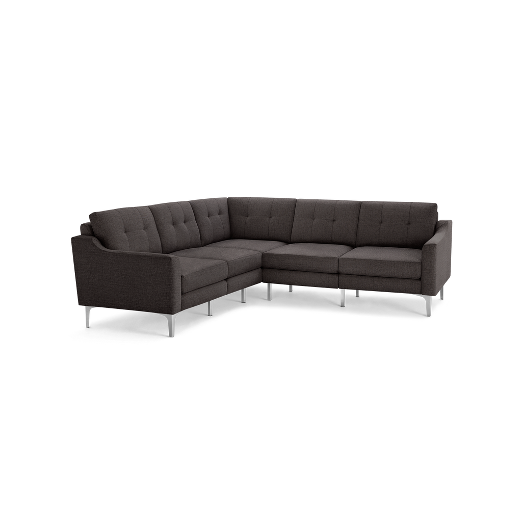 Dark gray fabric L-shaped sectional sofa with tufted back cushions and sleek metal legs, modern design.