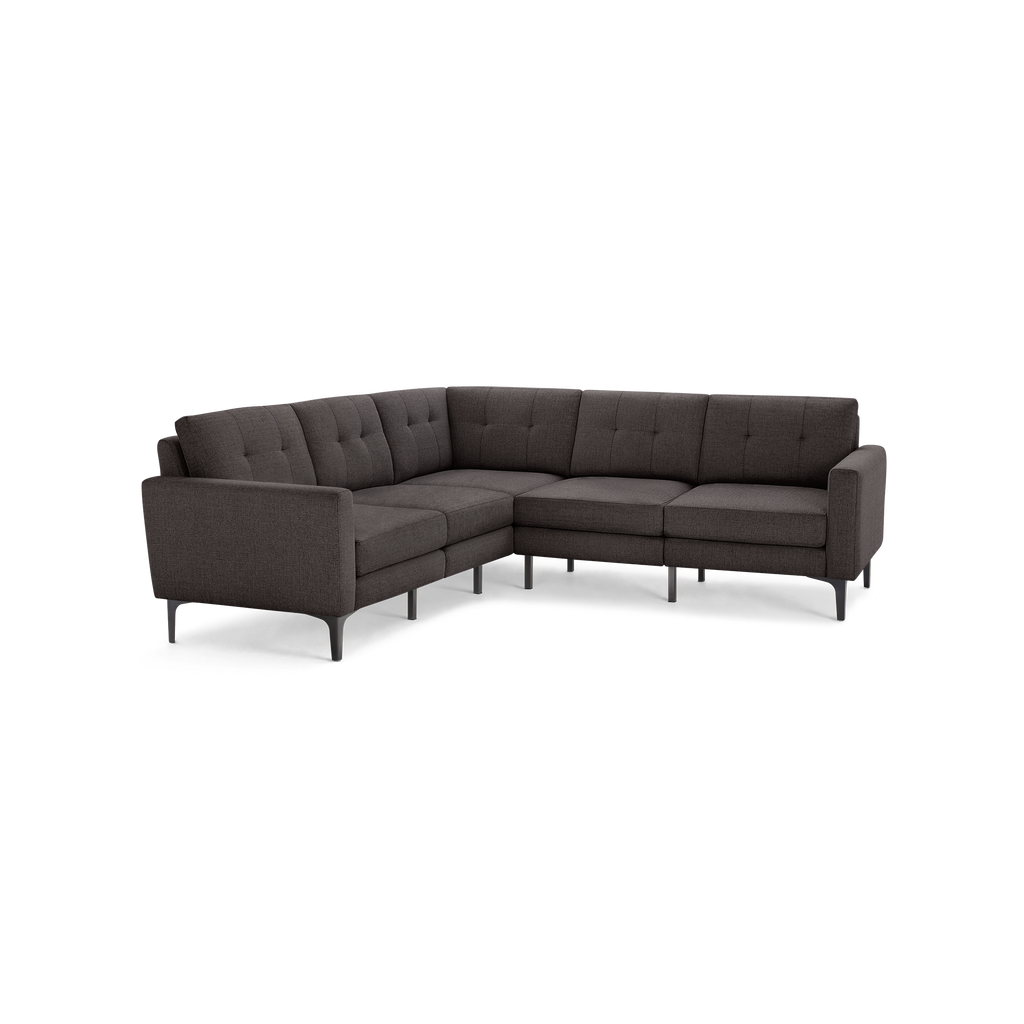 Dark gray fabric L-shaped sectional sofa with tufted back cushions and slim black legs.