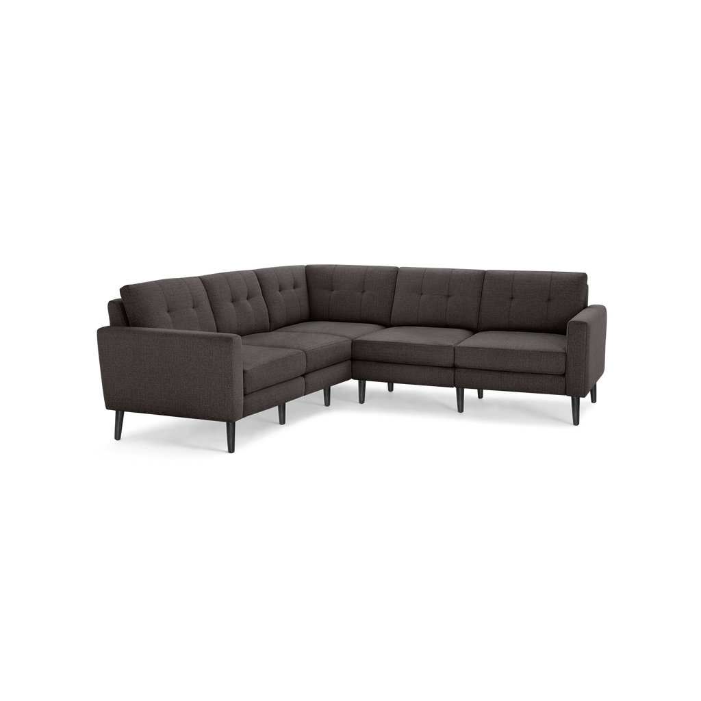 Modern dark gray fabric L-shaped sectional sofa with tufted back cushions and slender black legs.
