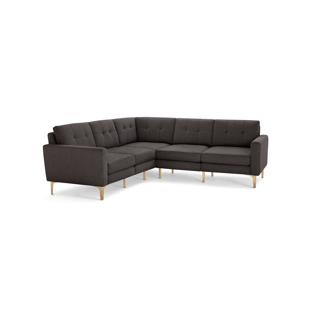 Dark gray fabric L-shaped sectional sofa with tufted back cushions and light wooden legs.